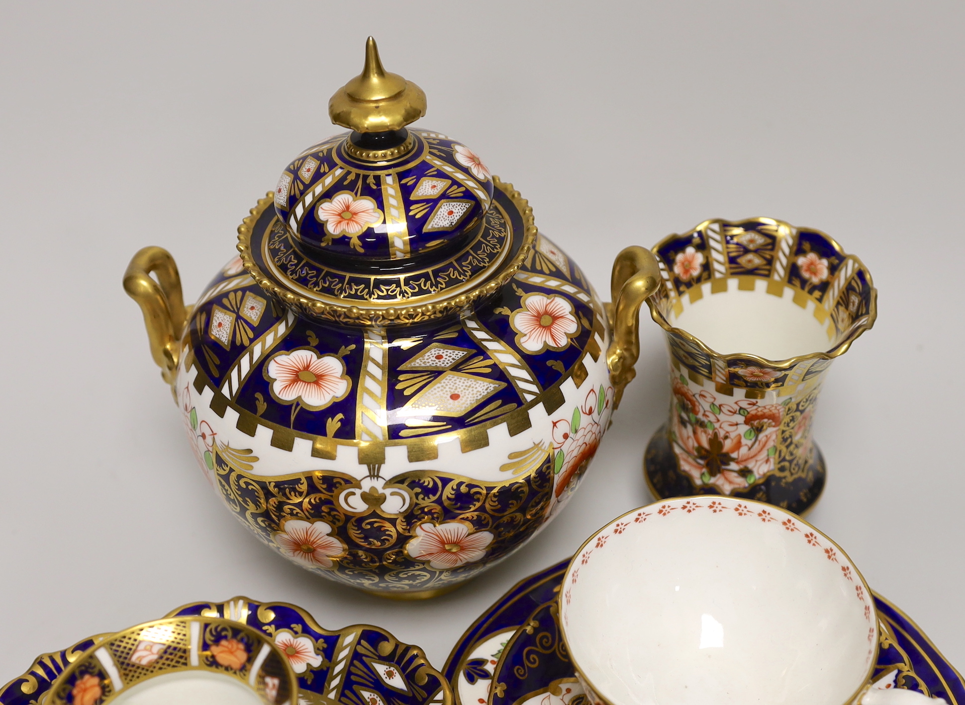 Seven pieces of Royal Crown Derby Imari porcelain including a trio and twin handled jar and cover, the largest 21cm high